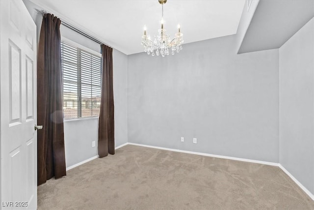 unfurnished room featuring a notable chandelier, carpet floors, and baseboards