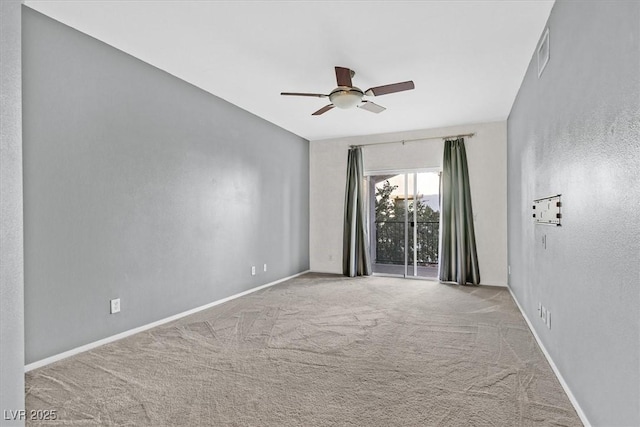 spare room featuring a ceiling fan, carpet, visible vents, and baseboards