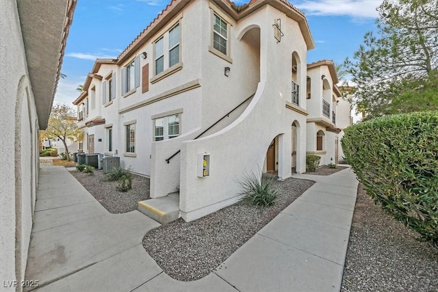 view of property exterior featuring a tile roof and stucco siding