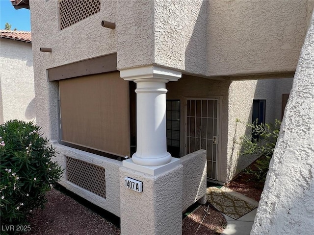 details with stucco siding and ornate columns