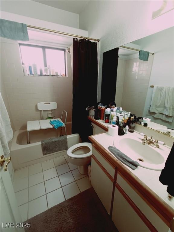 bathroom with shower / bath combo with shower curtain, vanity, toilet, and tile patterned floors