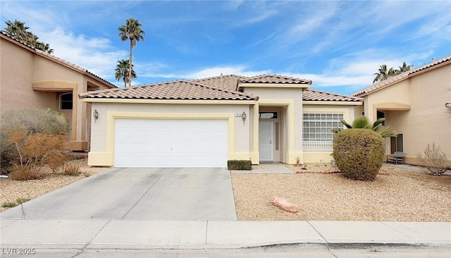 mediterranean / spanish-style house featuring driveway, an attached garage, a tile roof, and stucco siding