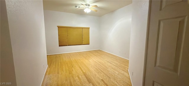 unfurnished room with wood finished floors and visible vents