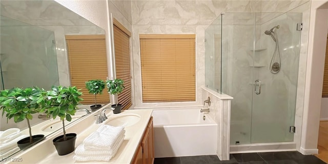 full bath with a shower stall, a bath, and vanity