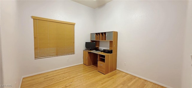 office area with light wood-style flooring and baseboards