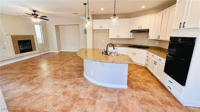 kitchen featuring white cabinetry, a sink, gas stovetop, and under cabinet range hood