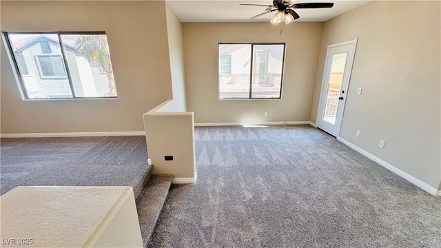 empty room with carpet floors, ceiling fan, and baseboards