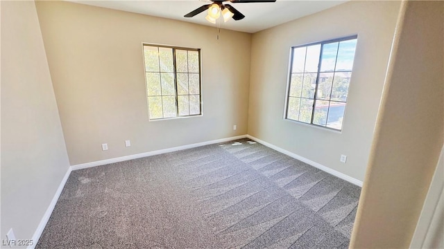 spare room featuring carpet floors, a ceiling fan, and baseboards