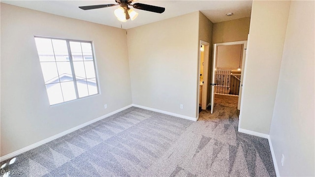 unfurnished bedroom with ceiling fan, carpet floors, and baseboards