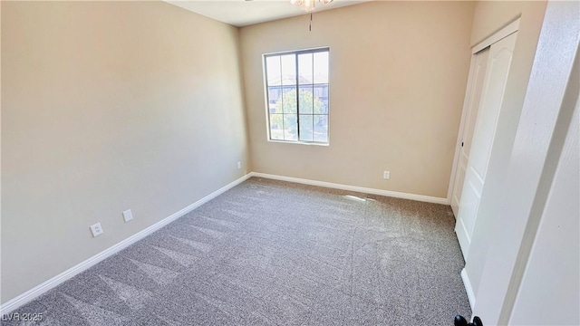 carpeted spare room with baseboards