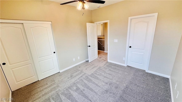 unfurnished bedroom with a closet, carpet, a ceiling fan, and baseboards