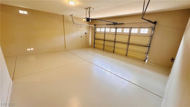 garage with baseboards and a garage door opener