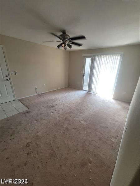 unfurnished room with light colored carpet and ceiling fan