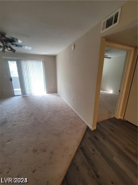 spare room featuring ceiling fan, carpet, and visible vents