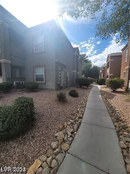 exterior space featuring central air condition unit and stucco siding