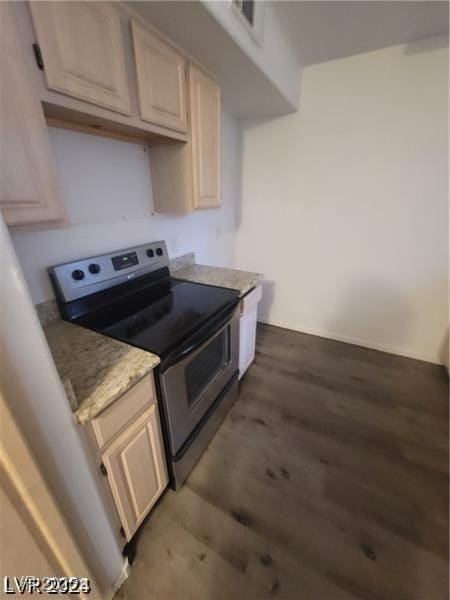 kitchen featuring stainless steel range with electric stovetop and wood finished floors