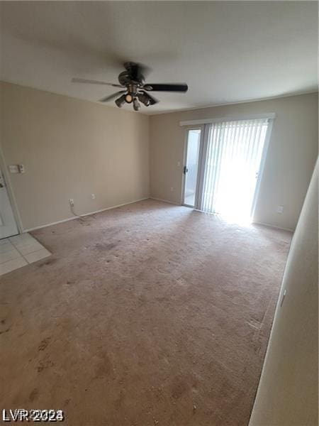 spare room with ceiling fan and light carpet