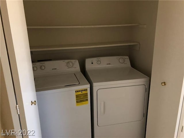 clothes washing area featuring laundry area and washer and clothes dryer