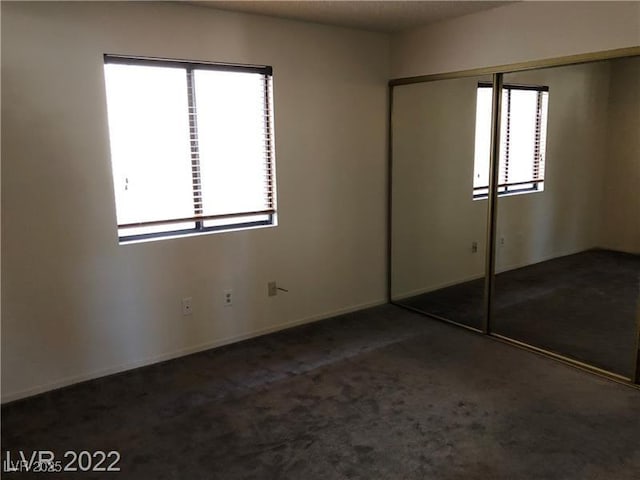 unfurnished bedroom featuring carpet floors and a closet