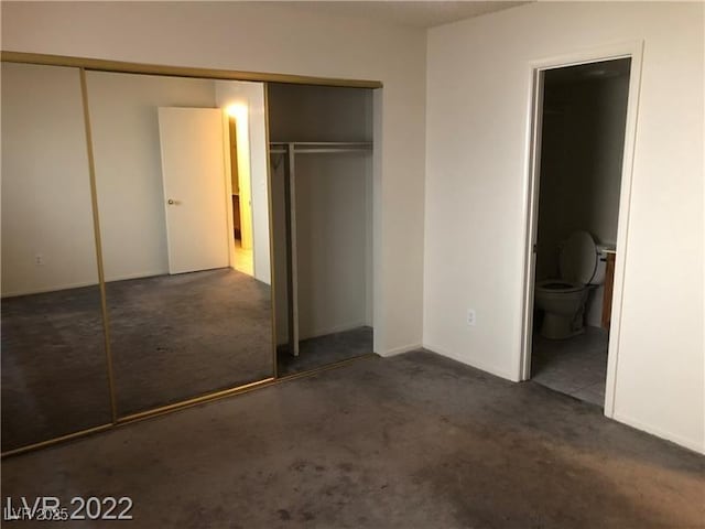 unfurnished bedroom featuring carpet floors and connected bathroom