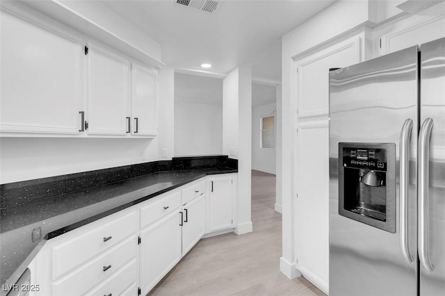 kitchen featuring stainless steel fridge, visible vents, white cabinets, light wood-style flooring, and recessed lighting