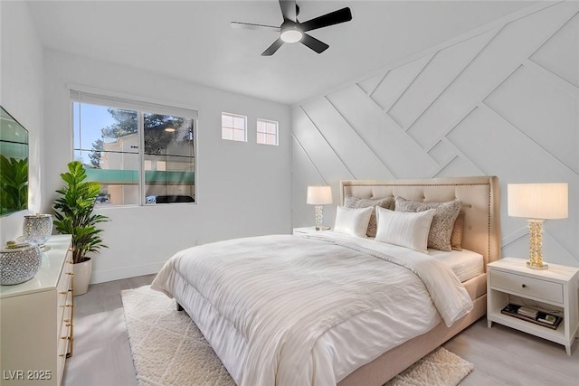 bedroom featuring ceiling fan, light wood finished floors, and baseboards