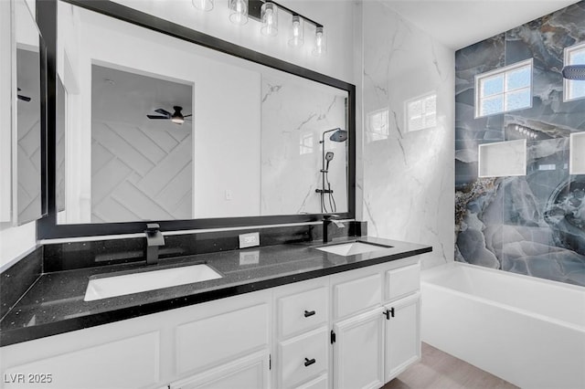 bathroom with double vanity, ceiling fan, and a sink