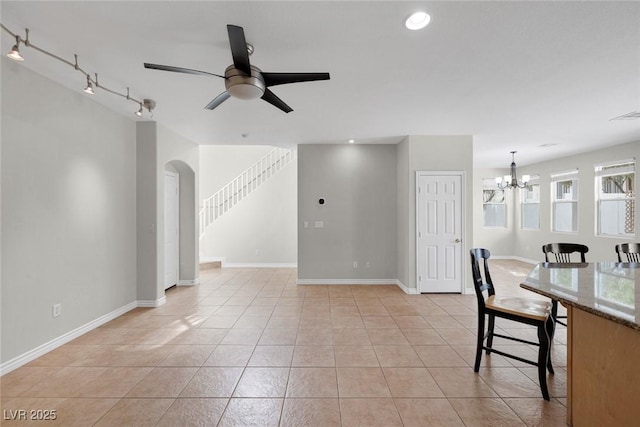 interior space with stairs, recessed lighting, light tile patterned flooring, baseboards, and ceiling fan with notable chandelier