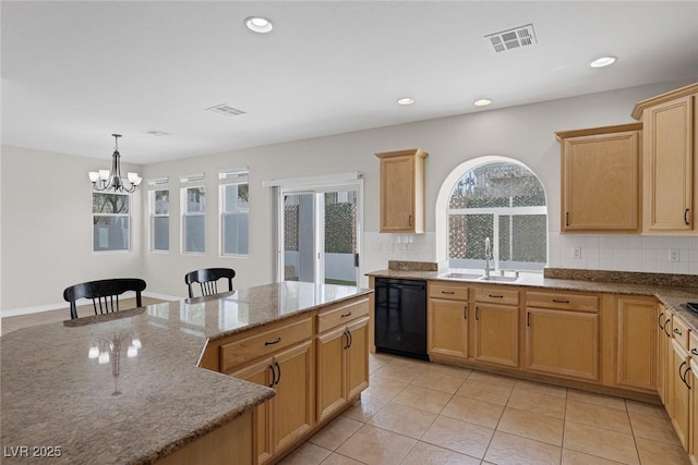 kitchen with stone countertops, a sink, visible vents, black dishwasher, and decorative backsplash