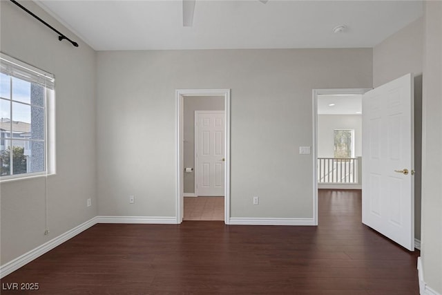 unfurnished bedroom with baseboards and wood finished floors