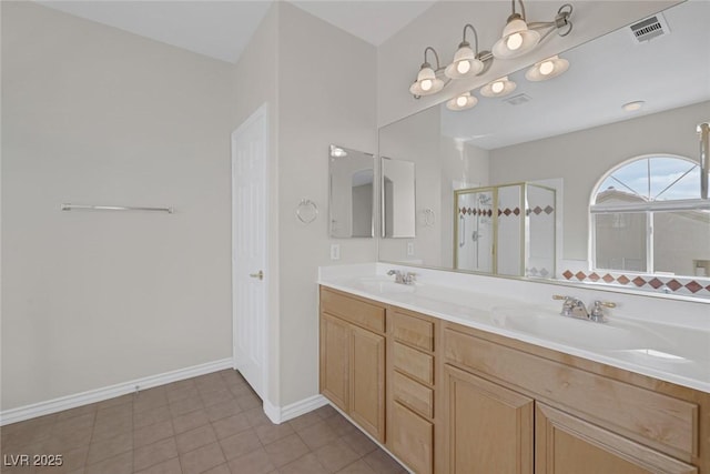 full bathroom with double vanity, a shower stall, visible vents, and a sink