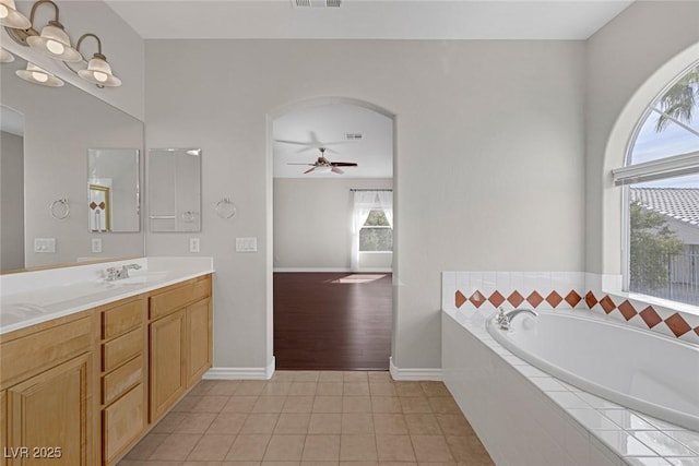 bathroom with visible vents, a ceiling fan, vanity, a bath, and tile patterned floors