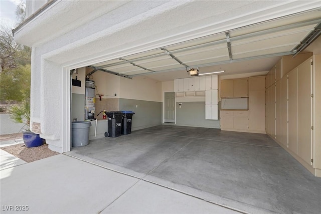 garage with water heater and a garage door opener