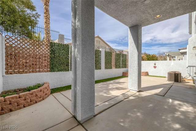 view of patio featuring a fenced backyard and central air condition unit