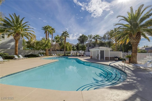 community pool with a patio and fence