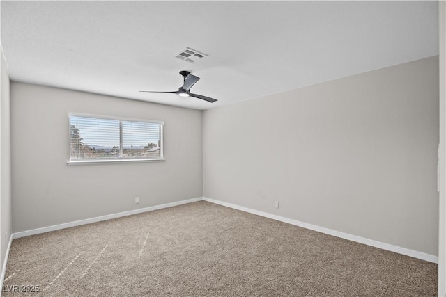 empty room featuring ceiling fan, carpet, visible vents, and baseboards