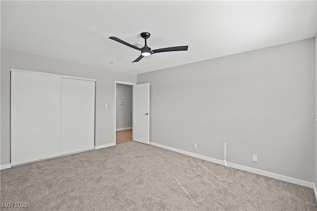 unfurnished bedroom featuring a ceiling fan, carpet, baseboards, and a closet