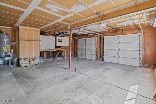 garage featuring a garage door opener and secured water heater