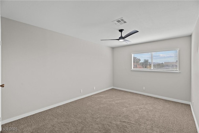 spare room with a ceiling fan, carpet, visible vents, and baseboards