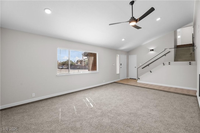 unfurnished living room featuring carpet floors, stairway, a ceiling fan, and baseboards