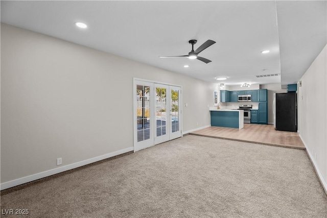 unfurnished living room with light carpet, recessed lighting, baseboards, and french doors