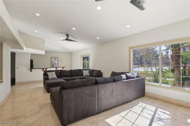 living area with vaulted ceiling, plenty of natural light, and recessed lighting