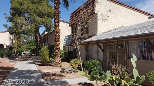 view of side of property with stucco siding