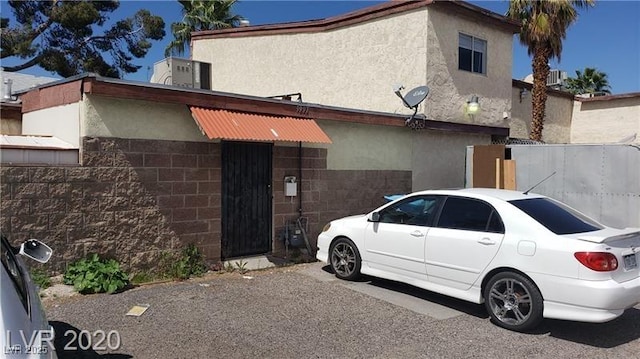 view of property exterior with concrete block siding and stucco siding