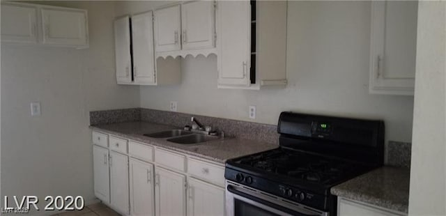 kitchen with white cabinetry, range with gas stovetop, and a sink