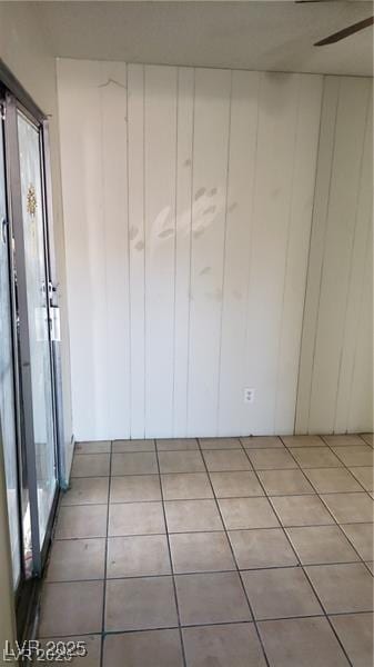 unfurnished room with tile patterned flooring and a ceiling fan