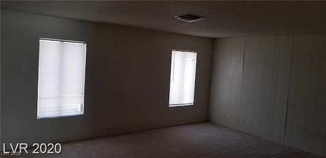 unfurnished room with a textured ceiling and visible vents