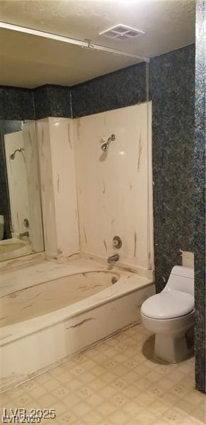 bathroom featuring toilet, tile patterned floors, visible vents, and shower / bathtub combination