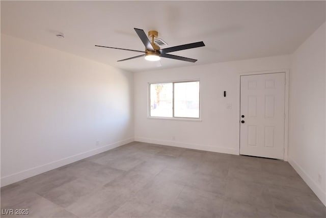 spare room with ceiling fan, visible vents, and baseboards