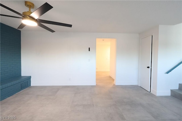 unfurnished room with stairs, a ceiling fan, and baseboards